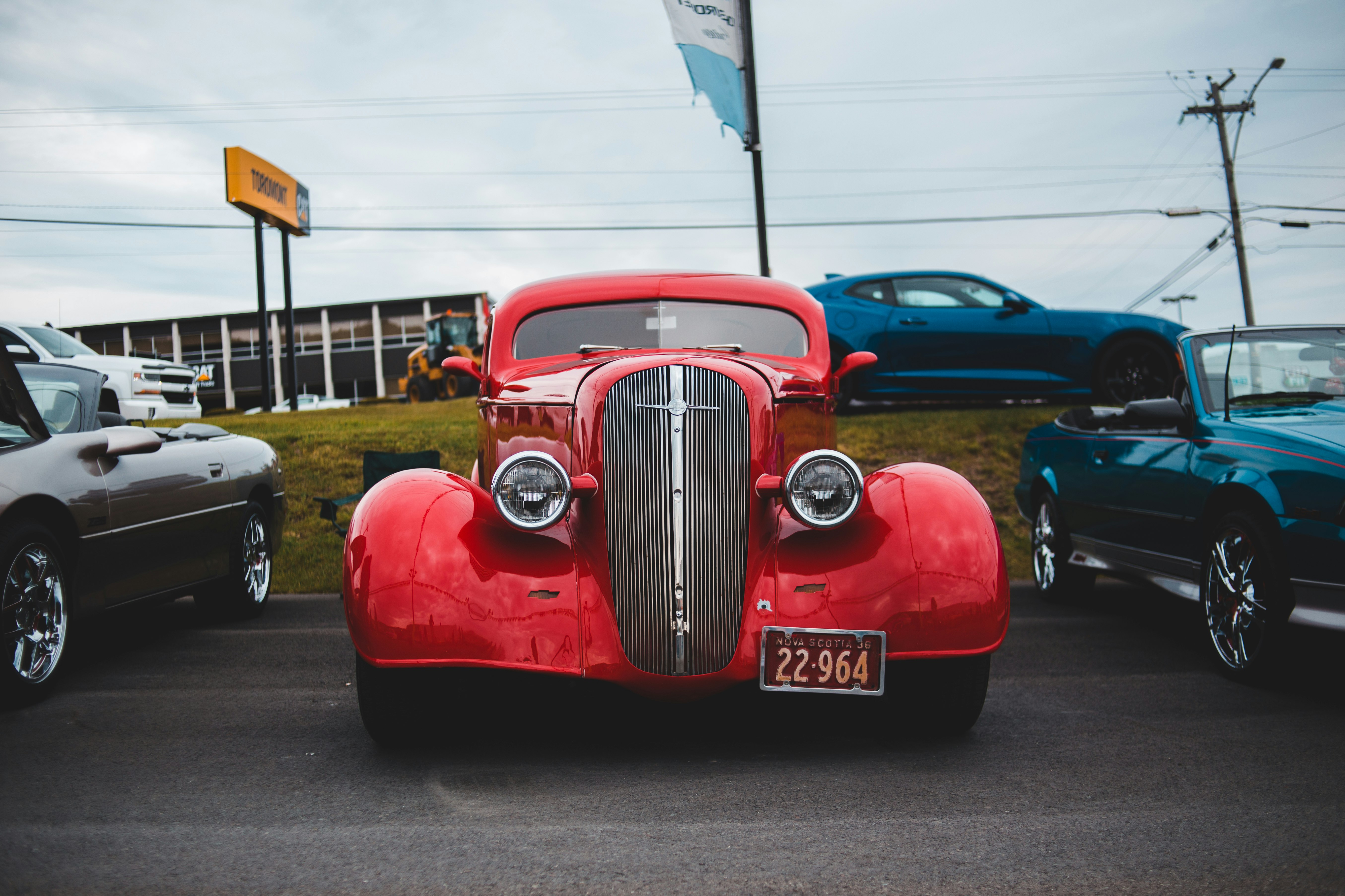 red vehicle near grass